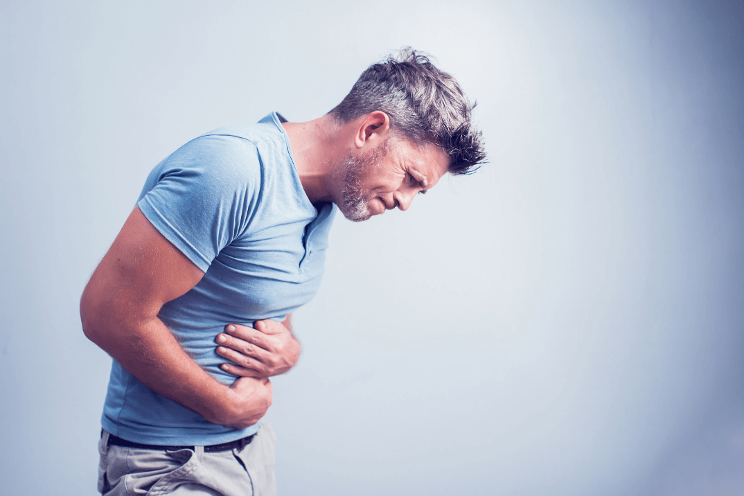 man in pain with upset stomach