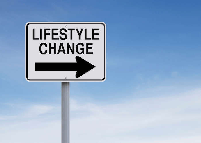 street sign that says lifestyle change with an arrow pointing to the right with the sky in background